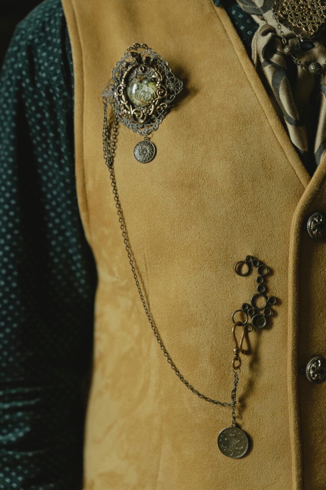 Close-up of a vintage vest adorned with chains and jewelry, creating an elegant and stylish look.